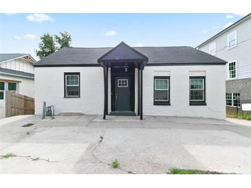 Charming home with a white exterior, black trim, and a covered entry at 3175 Dogwood Dr, Atlanta, GA 30354