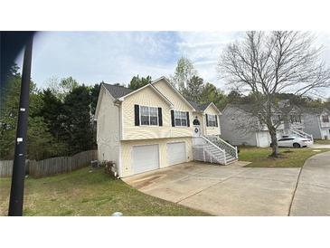 Charming two-story home with a two-car garage and welcoming front porch in a suburban neighborhood at 362 Summer Hill St, Stockbridge, GA 30281
