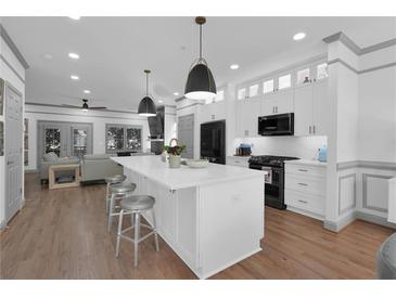 Bright, spacious kitchen featuring a center island, stainless steel appliances, and an open layout to the living room at 208 Wade Creek Rd, Alpharetta, GA 30009