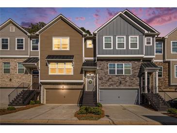 Charming townhomes with two-car garages and landscaped front yards at twilight at 2517 Hedgeway Cir, Kennesaw, GA 30144
