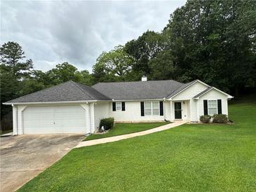 Charming single-story home featuring a well-manicured lawn and an attached two-car garage at 6328 Wellington Ct, Douglasville, GA 30134
