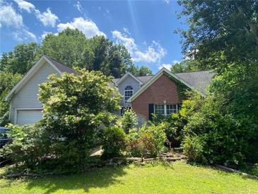 Charming two-story home with brick accents and a landscaped front yard at 5390 Regency Lake Court, Sugar Hill, GA 30518