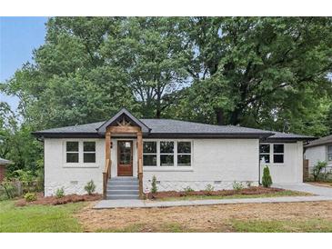 Charming one-story home with white painted brick, stone accents, and a covered front porch at 2244 Alpha Dr, Decatur, GA 30032