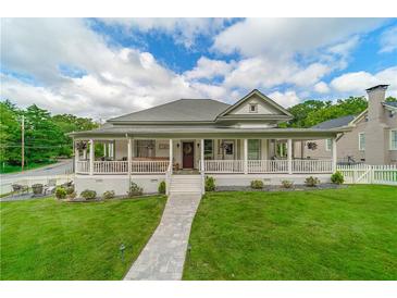 Charming home with a large wrap-around porch, walkway, well-manicured lawn and picturesque curb appeal at 4527 Dallas St, Acworth, GA 30101