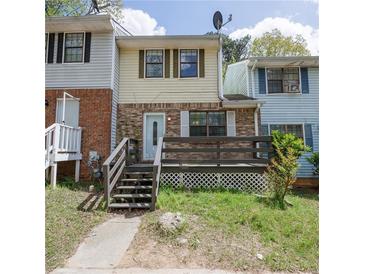 Charming townhome with a brick facade and a cozy front deck at 6991 Flagstone Dr, Austell, GA 30168
