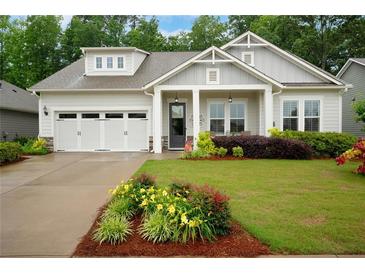 Charming single Gathering home with a lush front yard and a two-car garage at 219 Cordova St, Woodstock, GA 30189