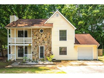Charming two-story home with stone accents and a welcoming front porch and one car garage at 2568 Redfield Dr, Norcross, GA 30071