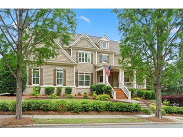 Charming two-story home featuring a well-manicured lawn and inviting front porch, perfect for relaxing outdoors at 4530 Westgate Dr, Cumming, GA 30040