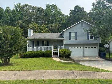 Charming two-story home with a well-manicured lawn and a two-car garage at 109 Ivy Crest Dr, Dallas, GA 30157