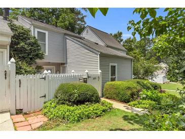Charming townhome with white picket fence and lush landscaping adding curb appeal at 2694 Greentree Se Dr, Marietta, GA 30067