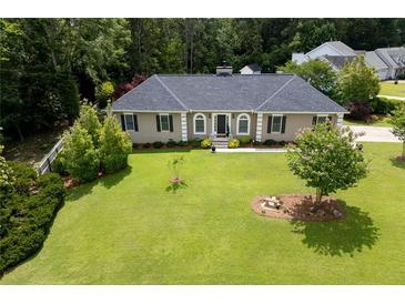 Charming home with lush green lawn and mature trees at 2265 Colony Dr, Canton, GA 30114
