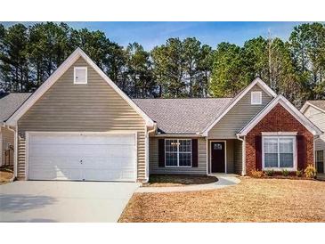 Charming single-story home with a two-car garage, brick accent and manicured lawn at 2350 Laurel Pointe Ln, Lawrenceville, GA 30043