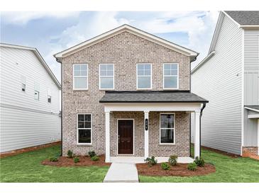 Charming two-story home featuring a classic brick facade and a welcoming front porch at 3021 Cambridge Mill St, Acworth, GA 30102