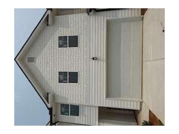 Home exterior featuring a two-car garage, white horizontal siding, and multi-pane windows at 1027 Merritt Dr # 98, Villa Rica, GA 30180