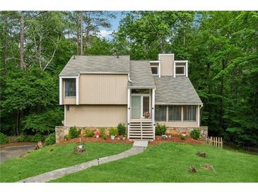 Charming home with a well-manicured lawn, stone accents and mature trees at 1720 Little Willeo Rd, Marietta, GA 30068