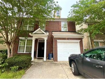 Charming two-story brick home with a covered entryway and attached single car garage at 1560 Park Grove Dr, Lawrenceville, GA 30046