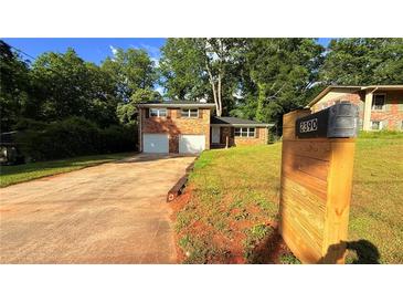Charming brick home featuring a two-car garage, well-maintained lawn, and mailbox with visible street number at 2390 Tiffany Pl, Decatur, GA 30035