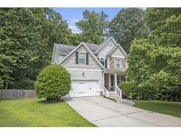 Charming two-story home featuring a manicured lawn and an attached two-car garage at 263 Chandler Ridge Dr, Douglasville, GA 30134