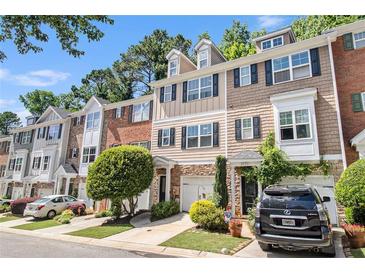 Charming townhomes featuring varied brick and siding with attached garages and manicured landscaping at 3068 Lauren Parc Rd, Decatur, GA 30032