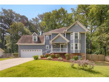 Charming two-story home with a well-maintained lawn and beautiful landscaping, complemented by a two-car garage at 3866 Teresa Sw Ter, Lilburn, GA 30047