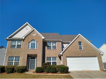 Charming brick two-story home with attached two-car garage and manicured landscaping at 838 Roxholly Ln, Buford, GA 30518
