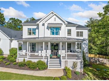 Charming two-story home with a welcoming front porch and professionally landscaped yard at 200 Whispering Pines Dr, Woodstock, GA 30188