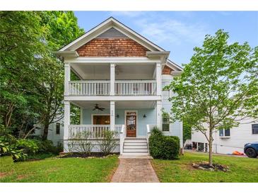 Charming two-story home featuring a double porch, wooden accents, and inviting curb appeal at 315 Melrose Ave, Decatur, GA 30030