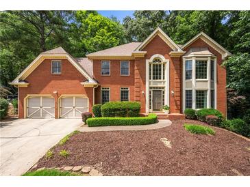 Charming brick home featuring a two-car garage and manicured front yard at 3741 Bays Ferry Way, Marietta, GA 30062