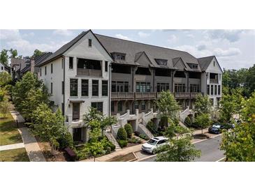 Charming townhome with beautiful landscaping, multiple stories, and a welcoming curb appeal at 6613 Encore Blvd, Atlanta, GA 30328