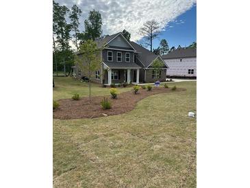 Charming new construction home featuring a landscaped front yard and covered entryway at 5000 Fairview Cir, Villa Rica, GA 30180