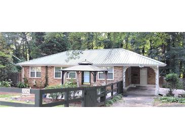 Charming brick home with a metal roof and welcoming front gazebo at 2225 Harold Se Ln, Smyrna, GA 30080