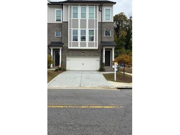 Charming townhouse with a two-car garage and a well-maintained front yard at 235 W Marietta St, Canton, GA 30114