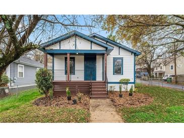 Charming home with a welcoming front porch and beautifully landscaped front yard at 819 Humphries St, Atlanta, GA 30310