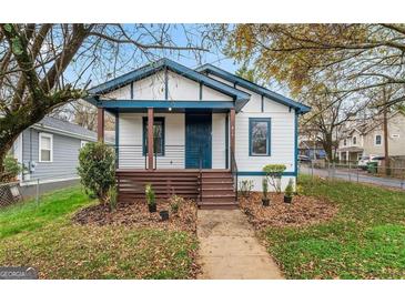 Charming home featuring a covered porch, freshly painted exterior, and a well-manicured front yard at 819 Humphries St, Atlanta, GA 30310