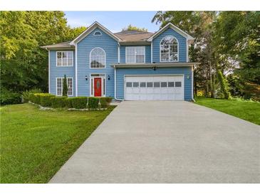 Charming two-story home with blue siding, an attached garage, and a well-manicured front lawn at 1901 Cherwell Dr, Riverdale, GA 30296