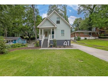 Charming light blue two-story home with a welcoming front porch and landscaped front yard at 41 Spring Nw Ln, Atlanta, GA 30314