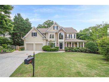 Charming two-story home features a two-car garage, manicured lawn, and classic architectural details at 4096 Vinings Mill Se Trl, Smyrna, GA 30080