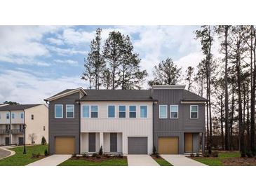 Beautiful townhome exteriors with modern color schemes and private driveways offer curb appeal at 1726 Gunnin Nw Trce # 231, Atlanta, GA 30318