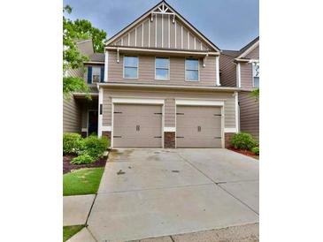 Two-story home with a two-car garage and well-maintained landscaping at 3277 Castleberry Village Dr, Cumming, GA 30040