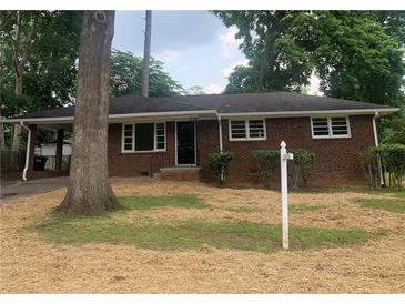 Charming brick ranch-style home with a covered carport and a traditional front yard at 4925 Sugar Valley Sw Rd, Mableton, GA 30126
