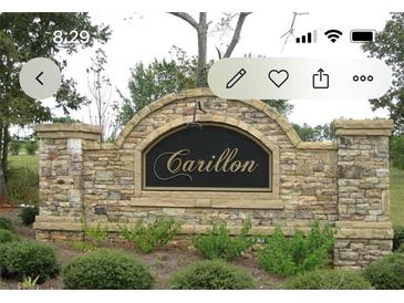 Stone entrance sign for Carillon subdivision with mature landscaping at 1128 Carillon Dr, Conyers, GA 30013