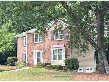 Charming two-story brick home with mature landscaping, featuring a welcoming front facade and well-maintained lawn at 2872 Bentwood Dr, Marietta, GA 30062