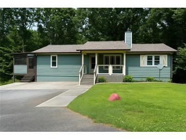 Charming single-story home featuring a screened porch, front porch, and inviting curb appeal at 259 Gramling Trl, Canton, GA 30114