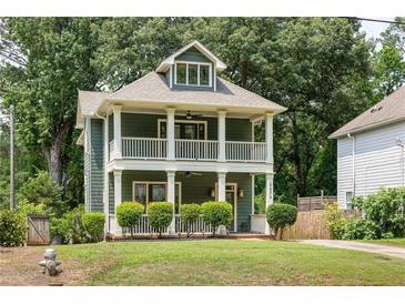 Charming two-story home featuring a double-decker porch and a well-maintained lawn at 2876 White Oak Dr, Decatur, GA 30032