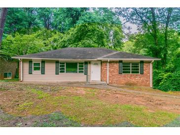 Charming ranch-style house with brick accents and a lush, green surrounding landscape at 2582 Springdale Sw Rd, Atlanta, GA 30315
