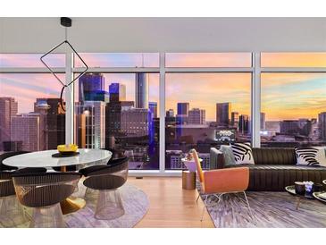 Modern living and dining area with stylish furniture and expansive city views through large windows at 45 Ivan Allen Jr Nw Blvd # 2505, Atlanta, GA 30308