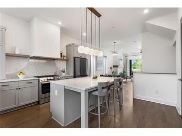 Modern kitchen features a large island, stainless steel appliances, and sleek gray cabinetry at 2347 Hosea L Williams Ne Dr # 11, Atlanta, GA 30317