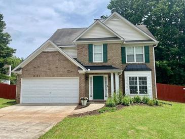 Charming two-story home with brick facade, green shutters, landscaped yard, and a two-car garage at 4424 High Gate Nw Dr, Acworth, GA 30101