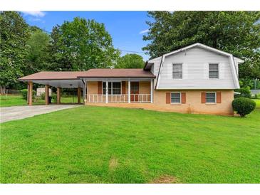 Charming home featuring a well-manicured lawn and a convenient covered carport at 2135 Knighton Dr, Atlanta, GA 30349
