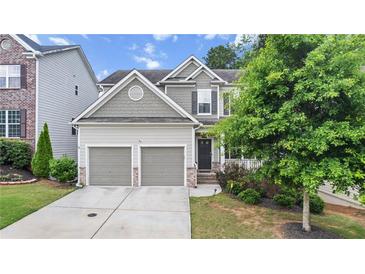 Charming two-story home with a two-car garage and beautifully landscaped front yard at 2013 Chesley Dr, Austell, GA 30106
